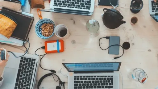 A bunch of laptops on a table from above